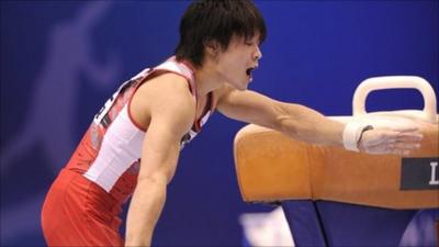 Kohei Uchimura of Japan falls from the pommel horse