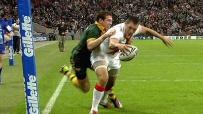 England's Ryan Hall goes over