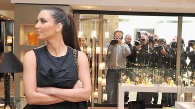 Kim Kardashian flanked by cameras