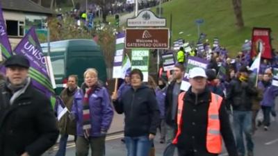 People marching holding union flags