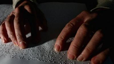 Man reading braille
