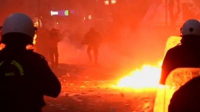 Protesters throw petrol bombs at riot police