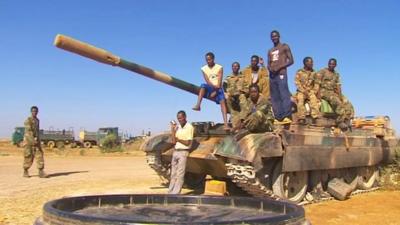 Soldiers sitting on a tank