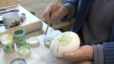 Woman painting eggs