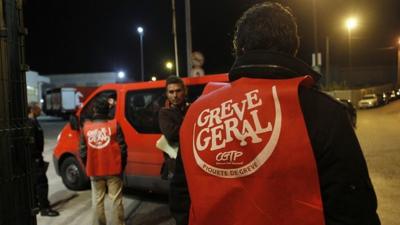 A worker who is part of a picket line tries to stop a mail van in Lisbon