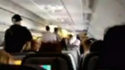 Footage appears to show the scene inside the plane