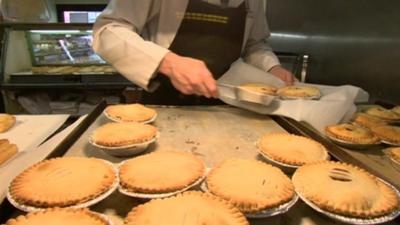 Hot pies being put on display