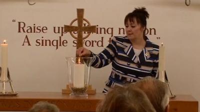 Margaret Allen lights the candle of remembrance