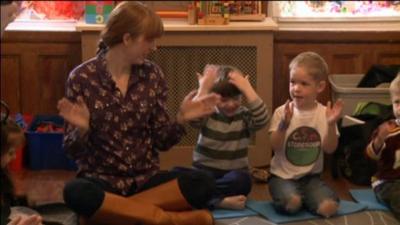 parent sits with children