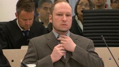 Anders Breivik straightens his tie as he sits in court