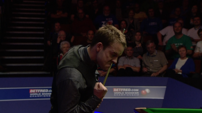 Ali Carter celebrates beating Judd Trump