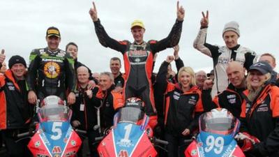 KMR Kawasaki team celebrate a clean sweep of the podium places