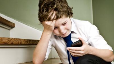 A boy using a mobile phone