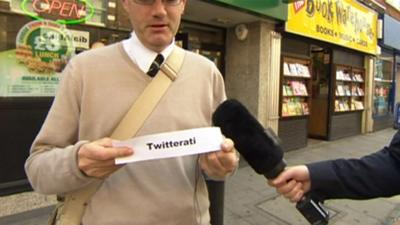 Man holding paper with word 'twitterati'