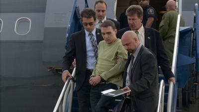 Luka Magnotta is escorted off a plane