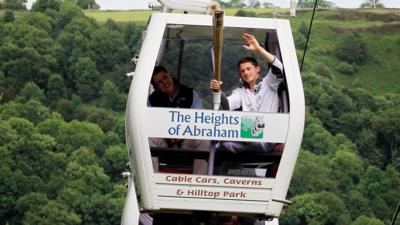 Dominick Cunningham carrying the Olympic flame on the Heights of Abraham sky-ride