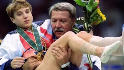 Kerri Strug being carried by US coach Bela Karolyi