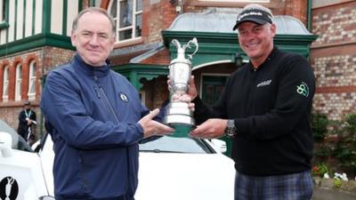 Darren Clarke hands back the Open trophy to R&A chief executive Peter Dawson