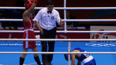 Japan's Satoshi Shimizu stands over Magomed Abdulhamidov of Azerbaijan