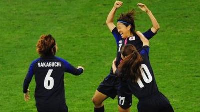 Yuki Ogimi of Japan celebrates with team mates Mizuho Sakaguchi and Homare Sawa after scoring the opening goal against Brazil