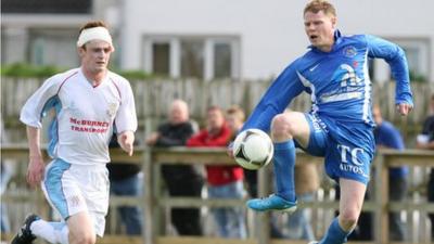 Aaron Stewart in action against Mark McConkey of Ballinamallard