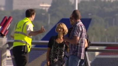Schiphol worker talking to passengers