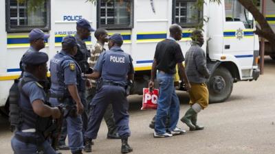 Police escort mineworkers on August 27