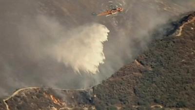 Helicopter dropping water on fire