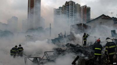 firefighters extinguish favela fire in Sao Paolo, Brazil