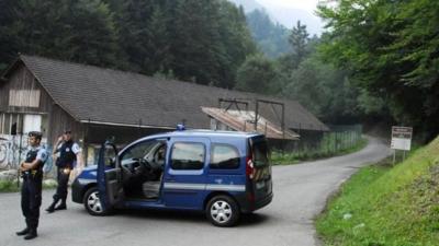 French gendarmes block the road leading to the scene where four people died in a shooting at a parking near the Annecy Lake, eastern France, on Wednesday