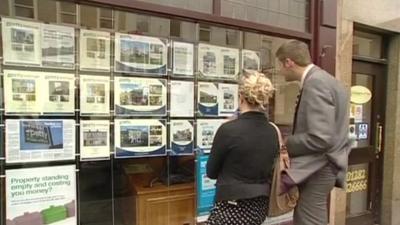 People looking in estate agents