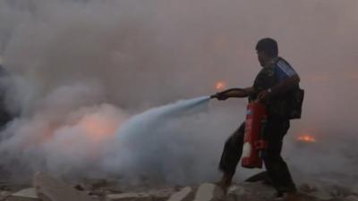 Local resident putting out a fire in Aleppo