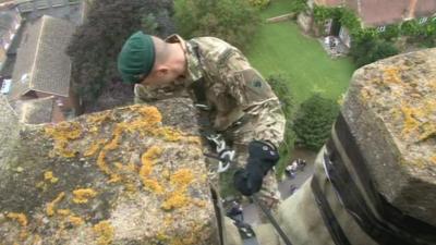 Marine starting his abseil down the church tower