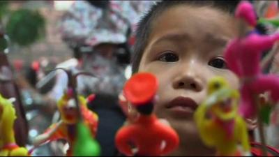 Young boy looking at toys