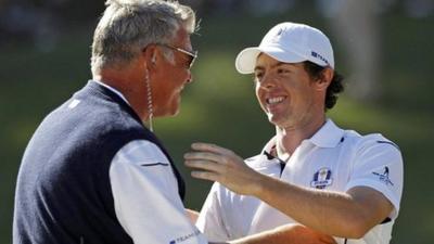 Darren Clarkes congratulates Rory McIlroy after his singles win over Keegan Bradley