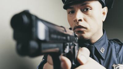 A US police officer holding a gun