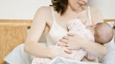 baby girl being breastfed