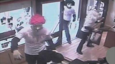 CCTV showing armed raiders inside a jewellery shop in Wigan