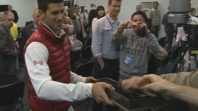 Novak Djokovic hands out chocolates