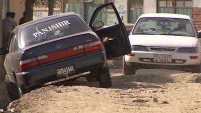 Car driving over unfinished road in Kabul