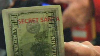 One of the specially-marked "Secret Santa" $100 bills
