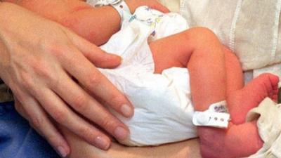 Newborn baby being held