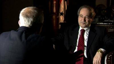 Deputy Foreign Minister Faisal Miqdad seated with the BBC's Middle East Editor Jeremy Bowen