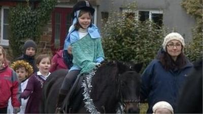 'Mary' makes her way through Walkhampton in the Lady Modiford Primary school Nativity play