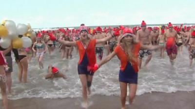 People run to take a bath in the North Sea