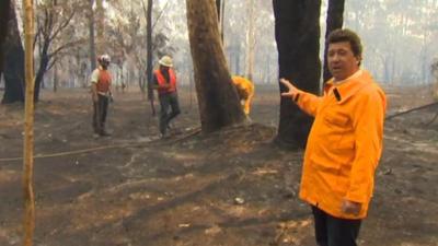 Nick Bryant looking at burned landscape