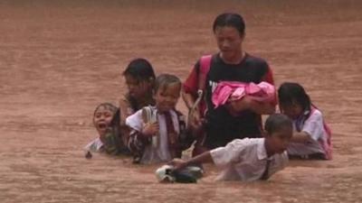 People battling through flood waters