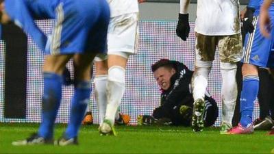 A ballboy lies on the ground after Chelsea's Eden Hazard had kicked out at him