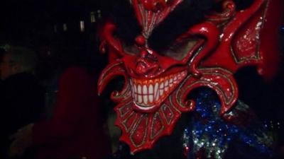 A person wearing a carnival mask