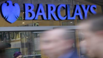 Glowing sign outside branch of Barclays